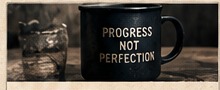 A mug marked Progress Not Perfection